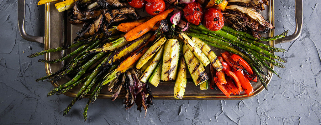 grilled vegetable platter with asparagus, zucchini, peppers, and tomatoes