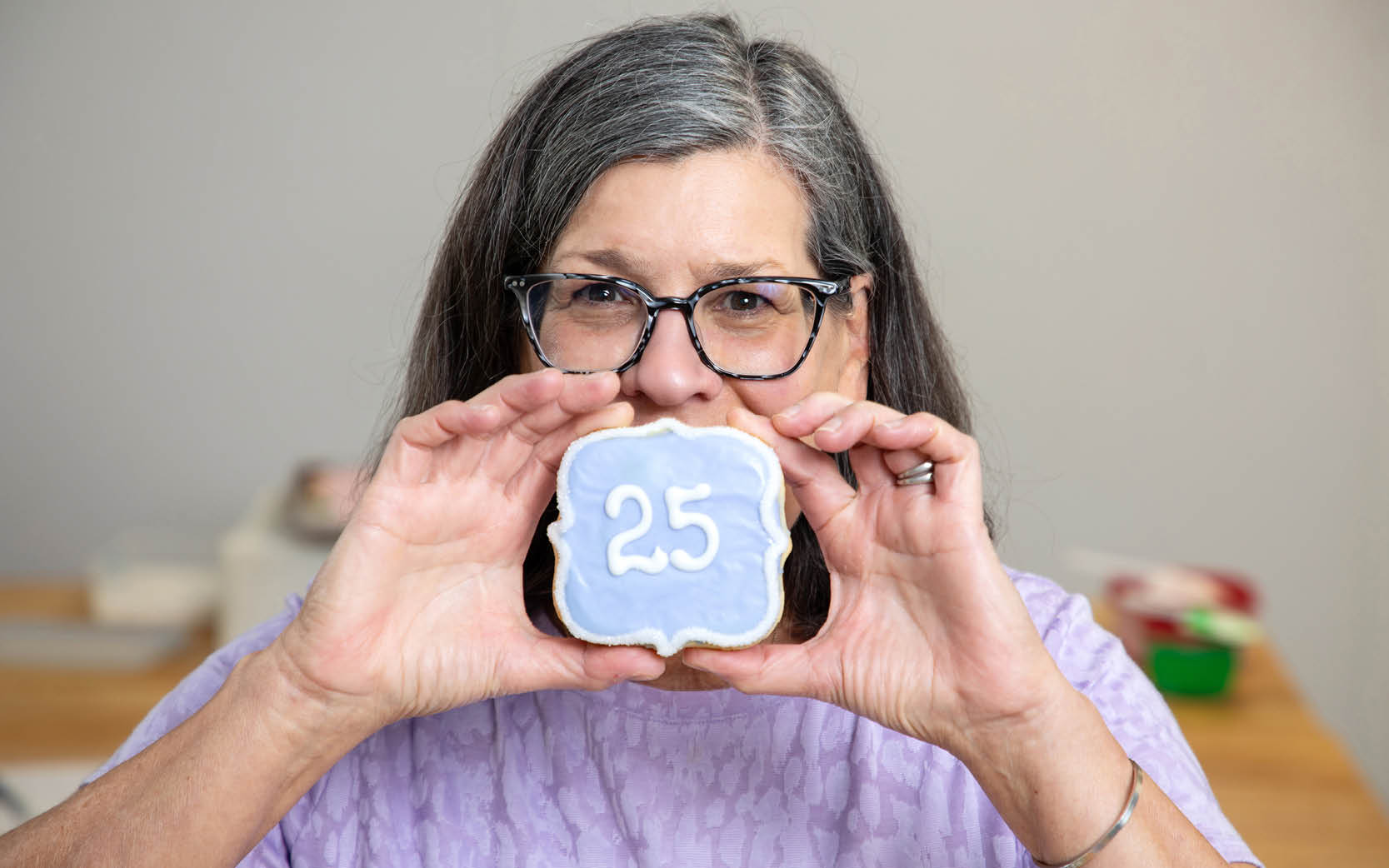 Laura holding 25 year anniversary cookie