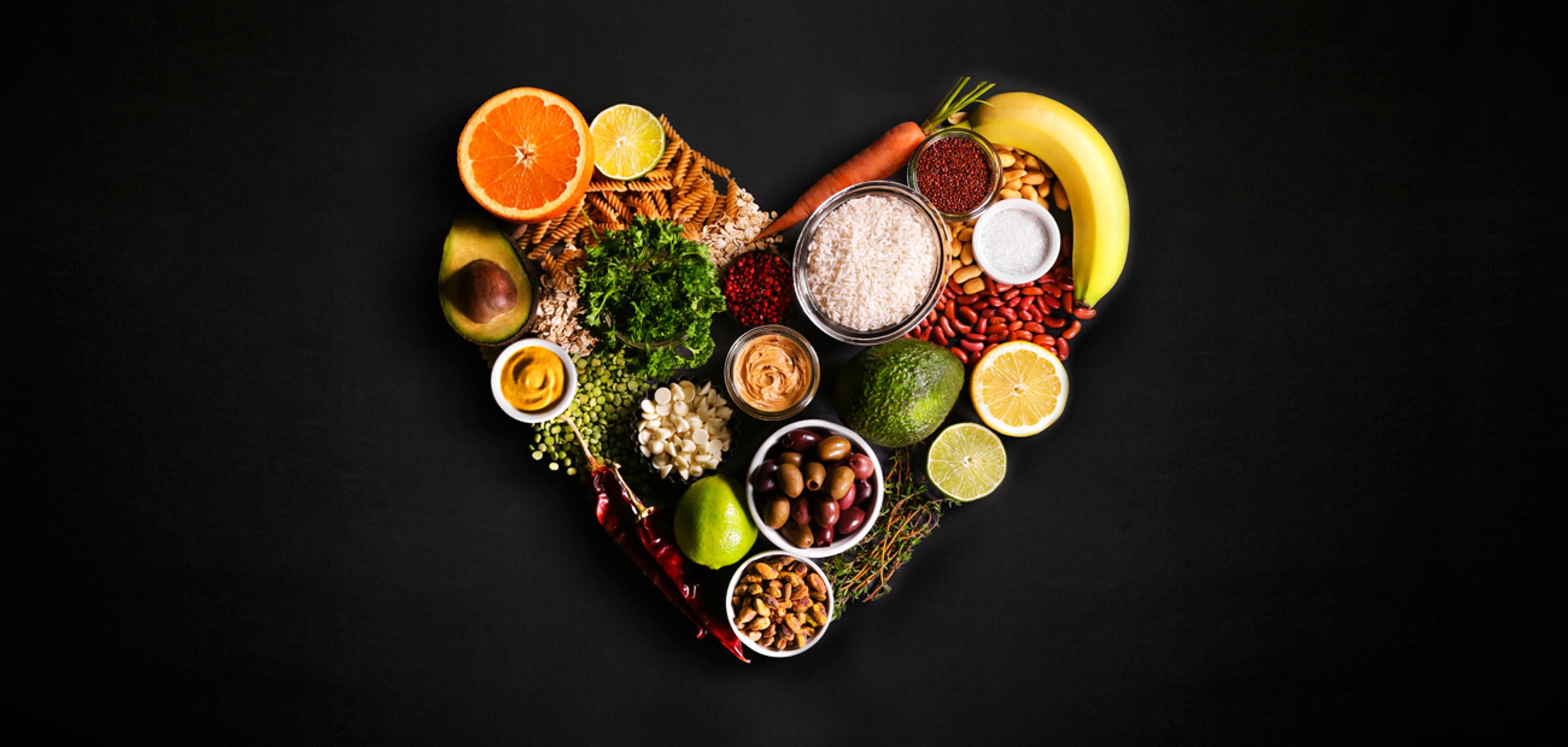 Heart of produce and pantry items, arranged with love across a backgorund