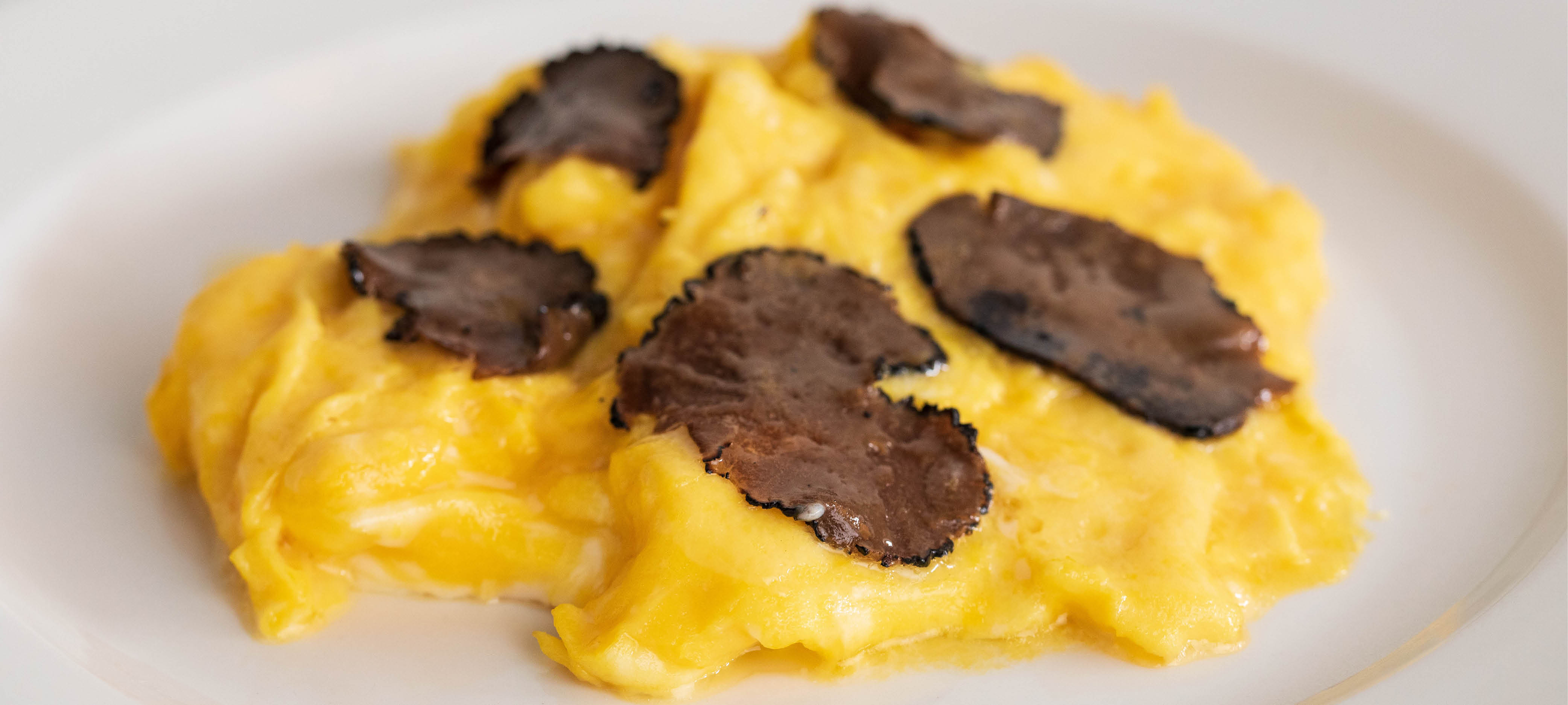 Scrambled Eggs Featuring Summer Truffle Slices.
