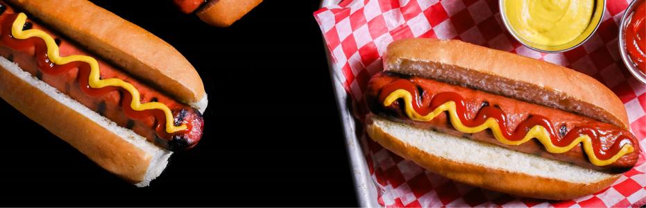 All-beef hot dog with ketchup and mustard, placed on a classic checkered background