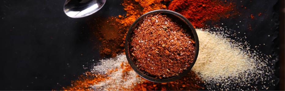 Bowl of spices over black background