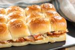 Heavenly Ham Slider Kit with Heavenly Ham, Kinig's Hawaiian rolls, Killer Brownie, cheese and mustard prepared and warm with cheese oozing out of the rolls