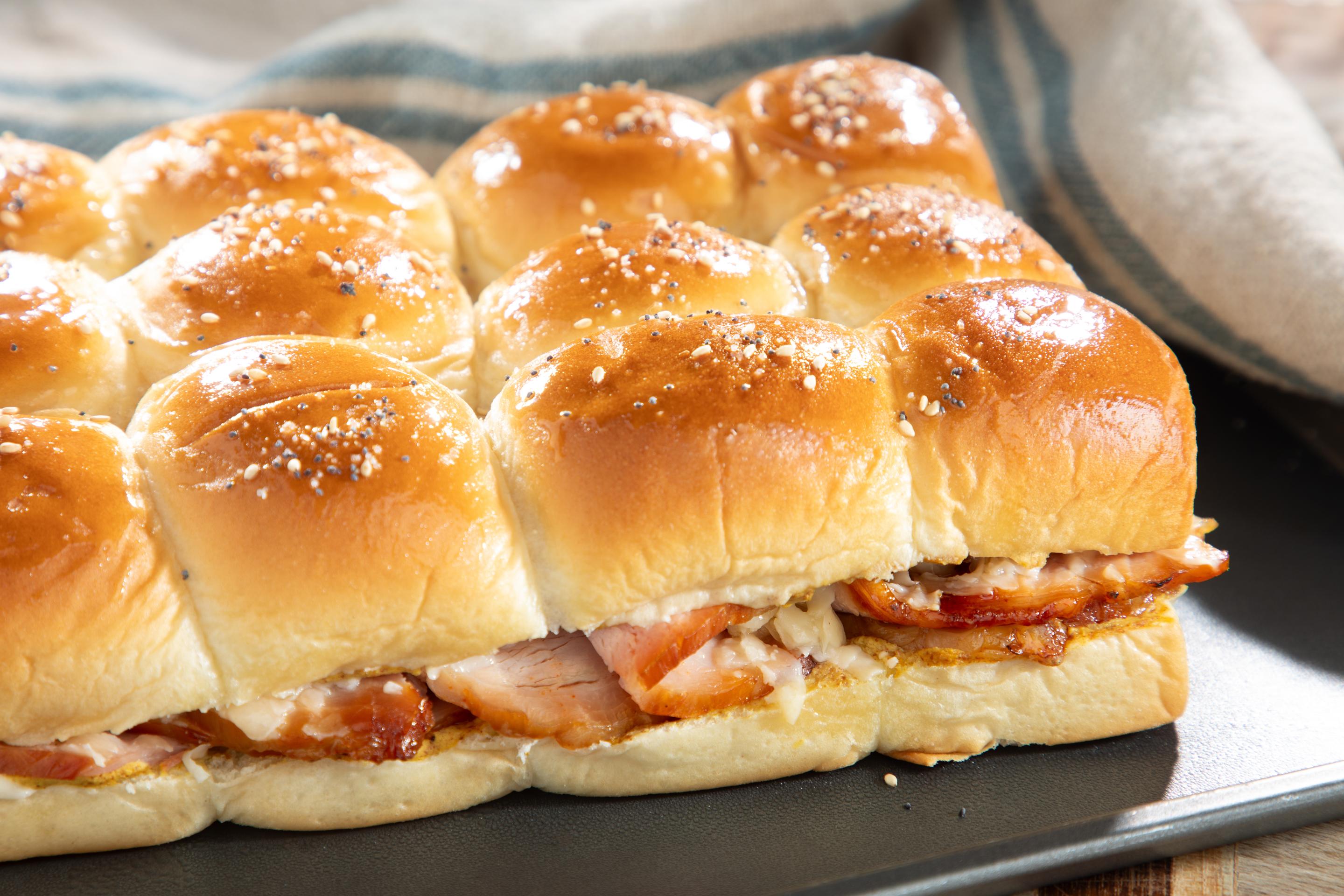 Heavenly Ham Slider Kit with Heavenly Ham, Kinig's Hawaiian rolls, Killer Brownie, cheese and mustard prepared and warm with cheese oozing out of the rolls