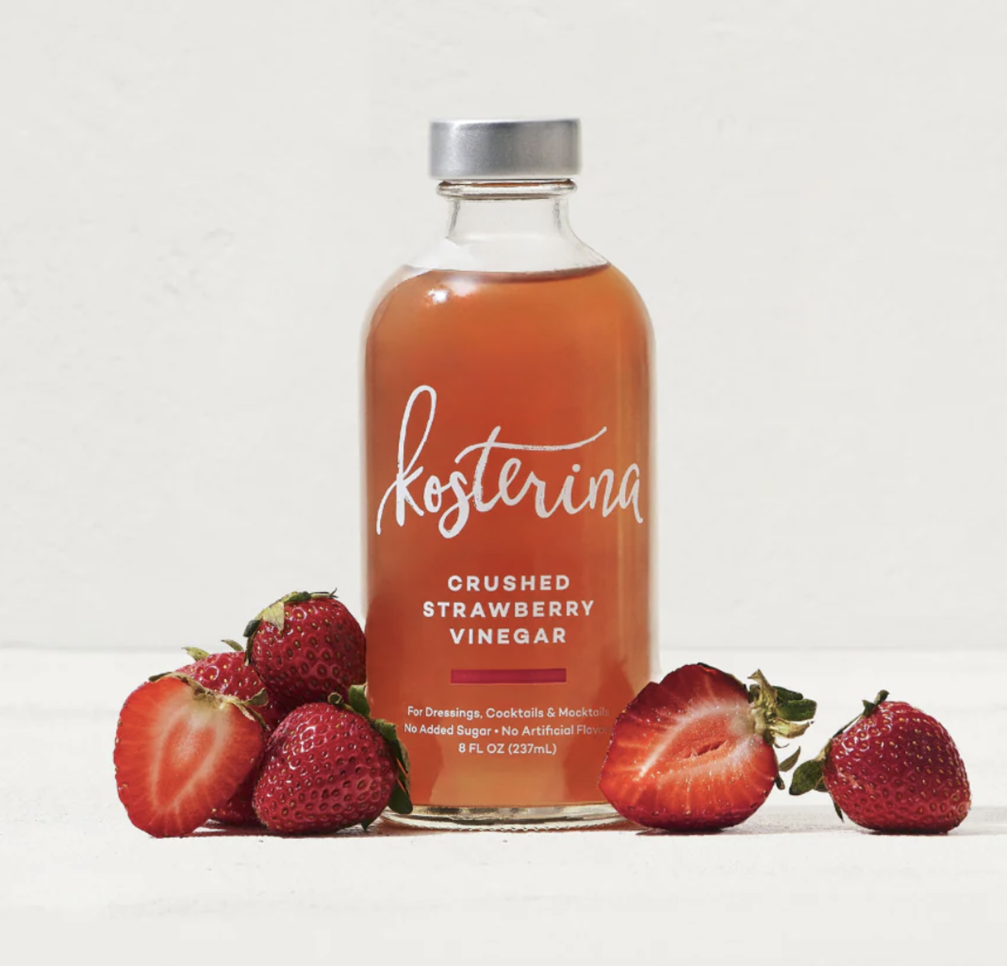 Kosterina Strawberry vinegar pictured with cut strawberries
