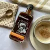 Rich amber Runamok organic Vermont maple syrup infused with cinnamon, ginger, nutmeg, vanilla, and clove