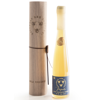 Savannah Bee Company Tupelo Gold Reserve Honey in a tall glass flute with a wooden gift case and leather ties