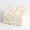 Close-up of an oversized marshmallow rice crispy treat showing a soft, gooey texture and crisp cereal.