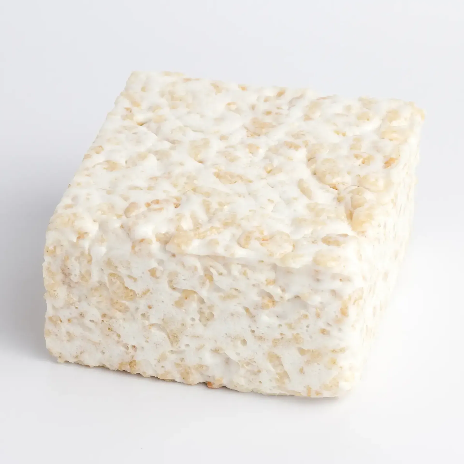 Close-up of an oversized marshmallow rice crispy treat showing a soft, gooey texture and crisp cereal.