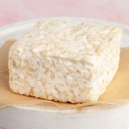 The Crispery Plain and Sweet gourmet marshmallow rice crispy cake individually wrapped on a light background.